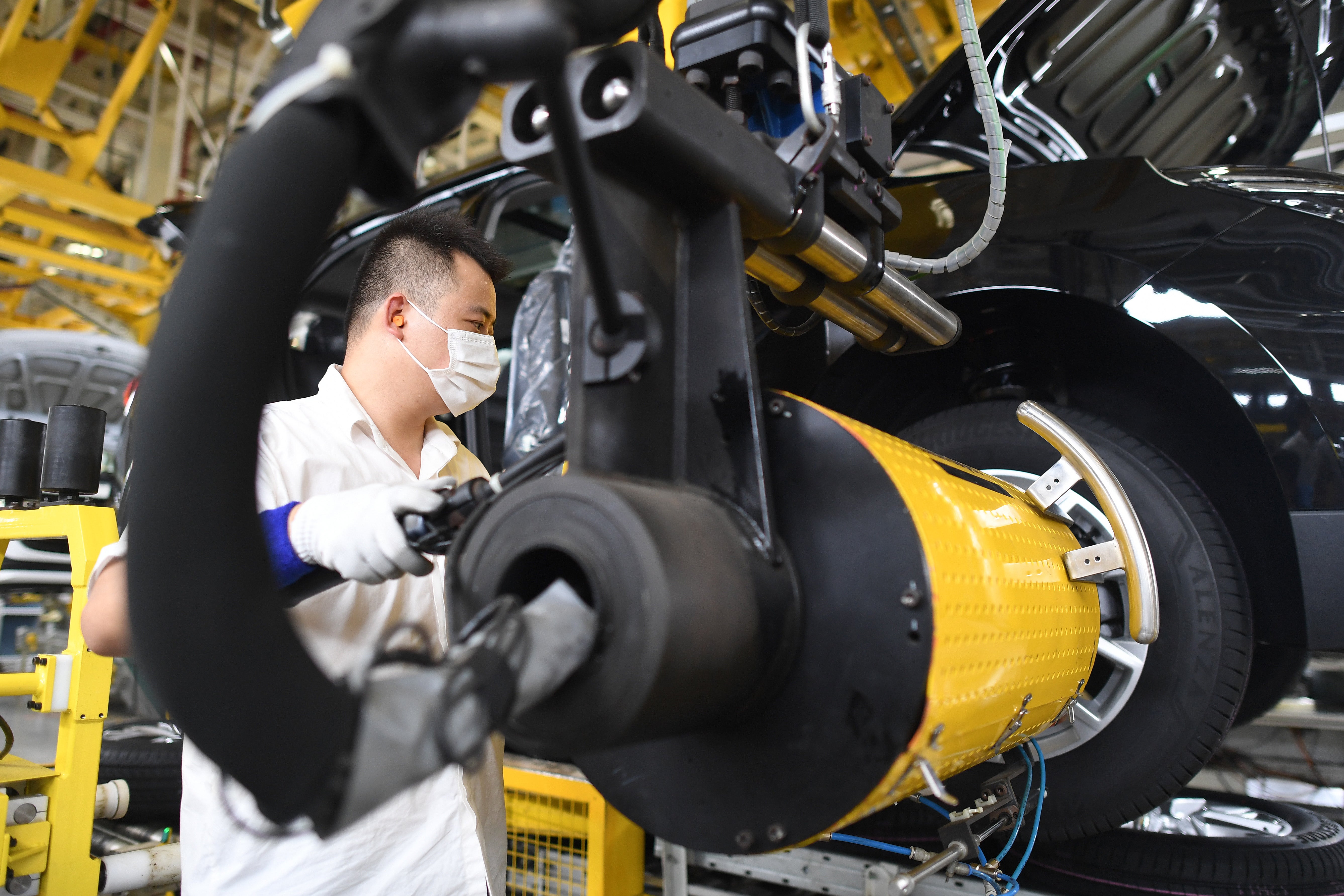 An employee works on the production line of an automobile joint venture in Wuhan, Hubei province