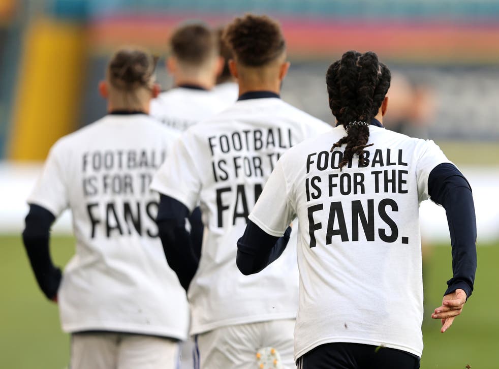 ‘Football Is For The Fans’ t-shirts are worn by Leeds players during the warm-up of last season’s game with Liverpool (Clive Brunskill/PA)