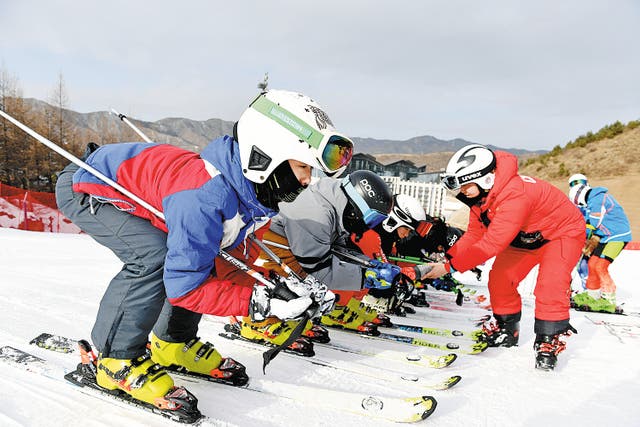 <p>Teenagers take ski lessons at a training base in the Beijing 2022 Winter Olympics’ Zhangjiakou competition zone, North China’s Hebei province, on 15 December 2021.</p>