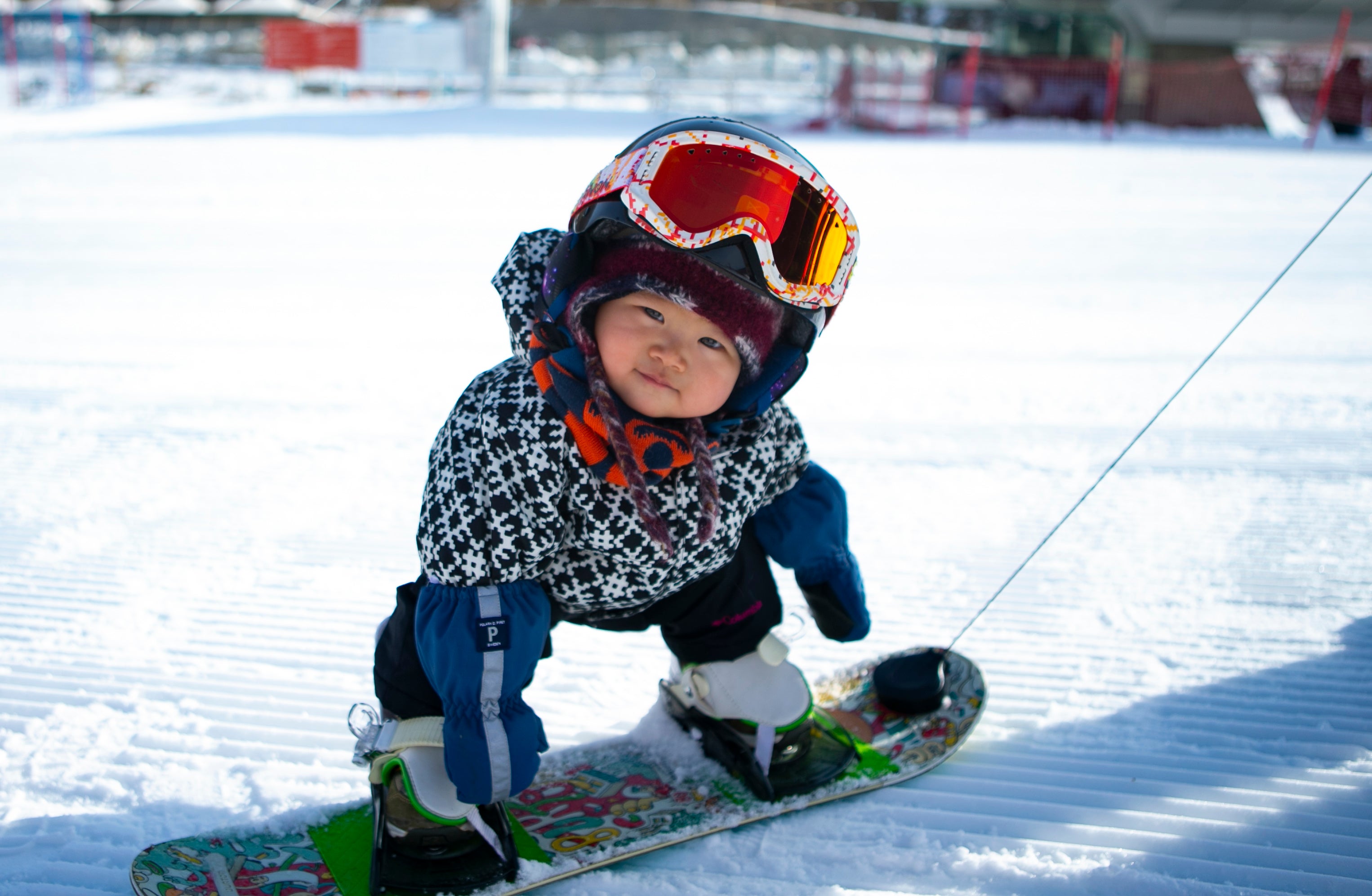 A toddler enjoys her first attempt at skiing at a ski resort in Zhangjiakou in November, 2021
