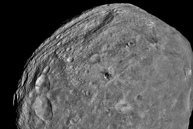 <p>In this handout from NASA, the giant asteroid Vesta is seen in an image taken from the NASA Dawn spacecraft about 3,200 miles above the surface July 24, 2011 in Space. </p>
