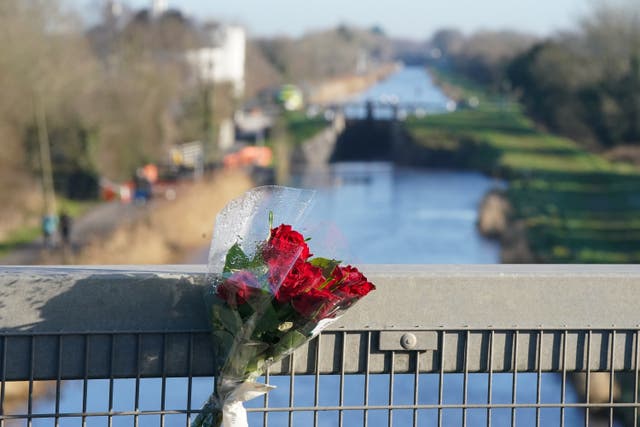 Red roses placed on the bridge across the Grand Canal in Tullamore (Niall Carson/PA)