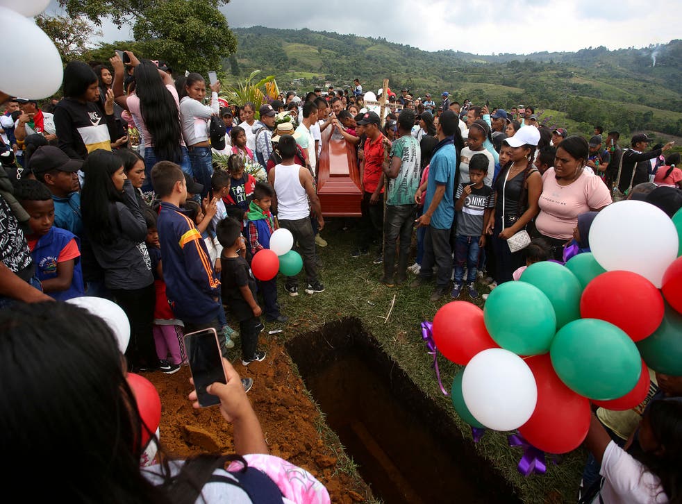 <p>People attend the burial of Colombian 14-year-old environmental activist Breiner David Cucuname, who was shot dead during a rural security patrol on 14 January 2022</p>