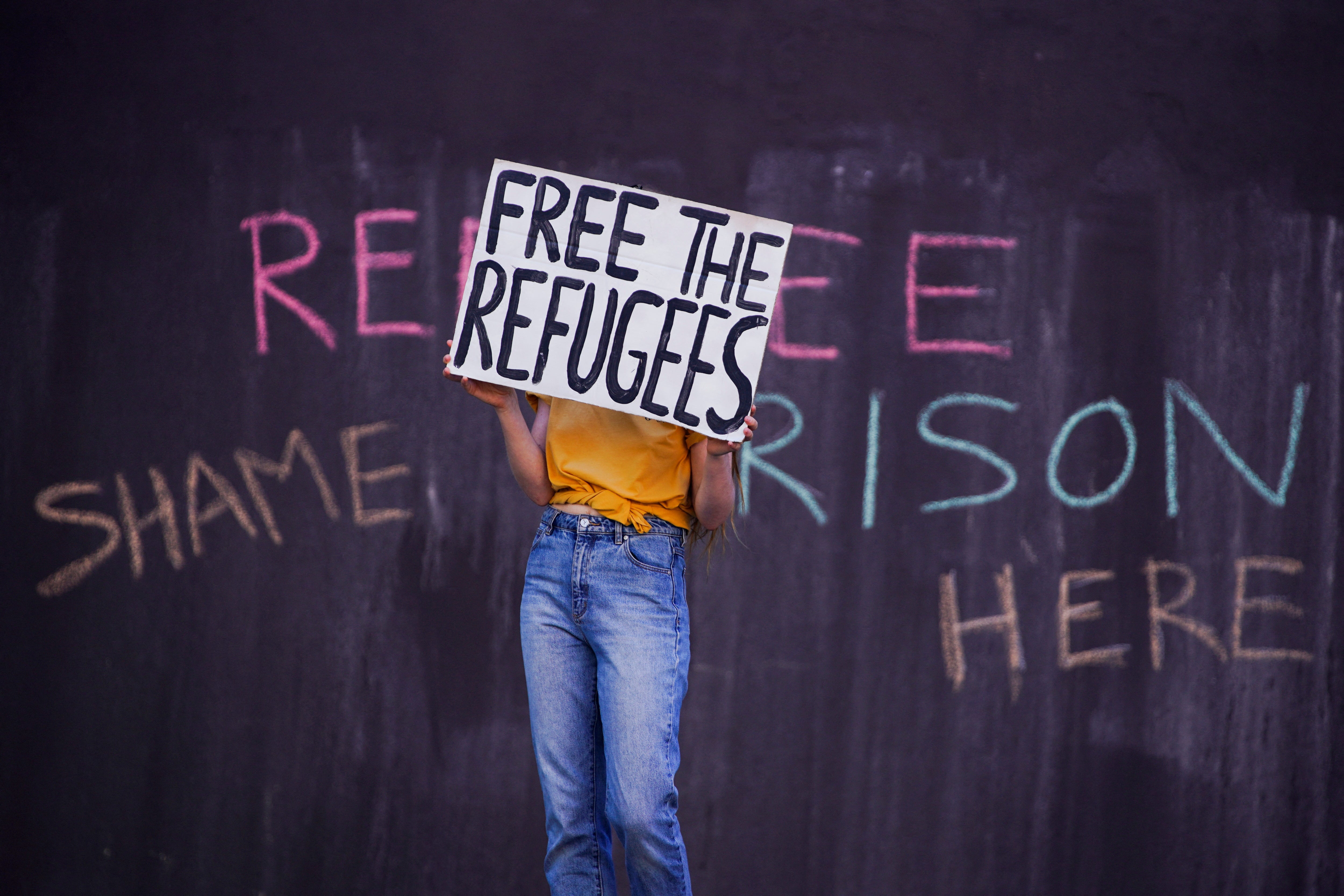 File photo: A pro-refugee protestor demonstrates in front of the Park Hotel where Novak Djokovic was held in Melbourne, Australia, 15 January 2022