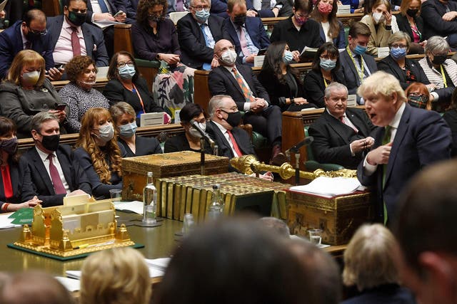 <p>Tory defector Christian Wakeford sits behind the Labour leader, Keir Starmer, left, as Boris Johnson speaks during PMQs  </p>