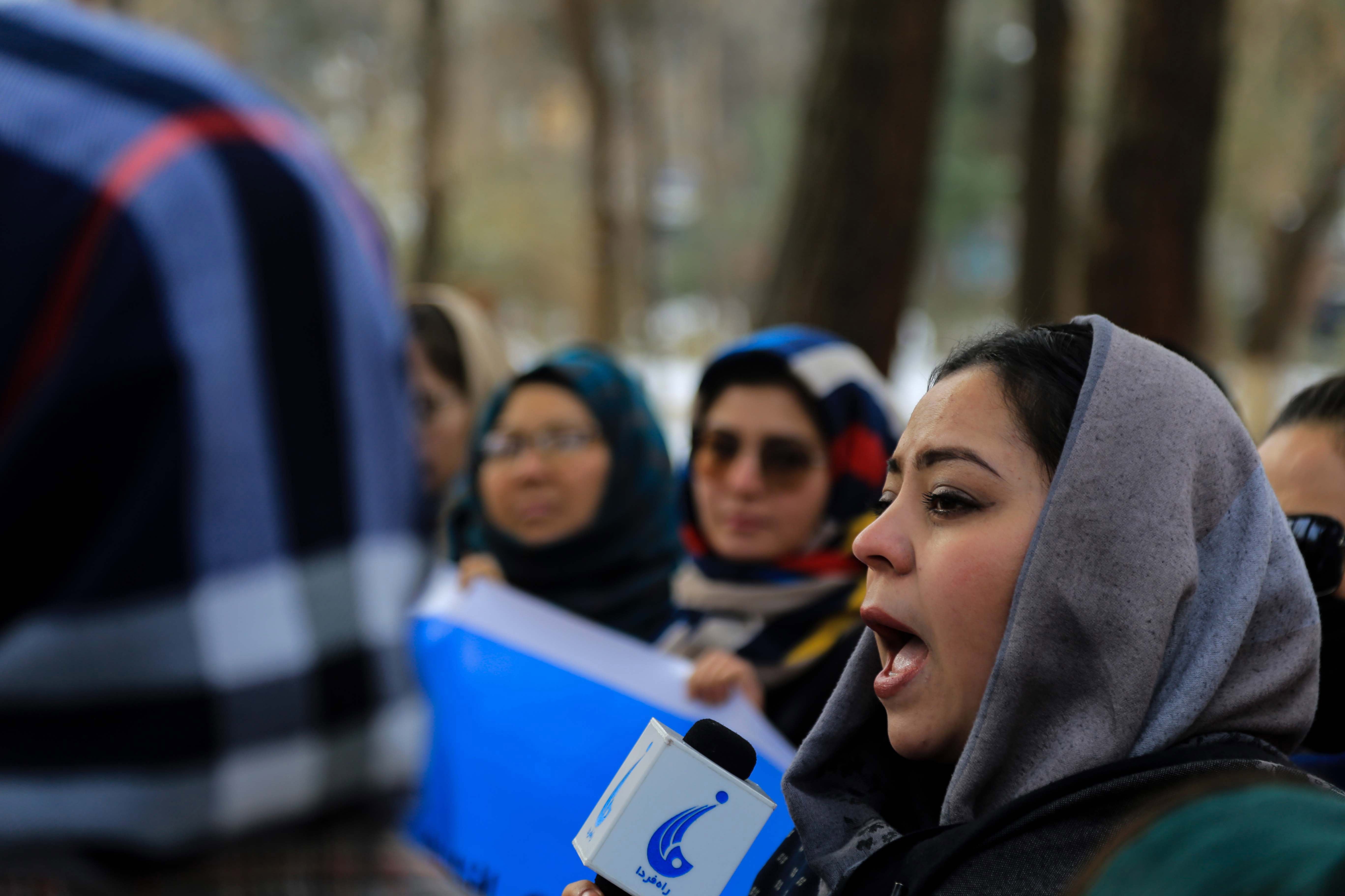 File photo: Afghan women and activists hold a banner during a protest in Kabul on 12 January 2022