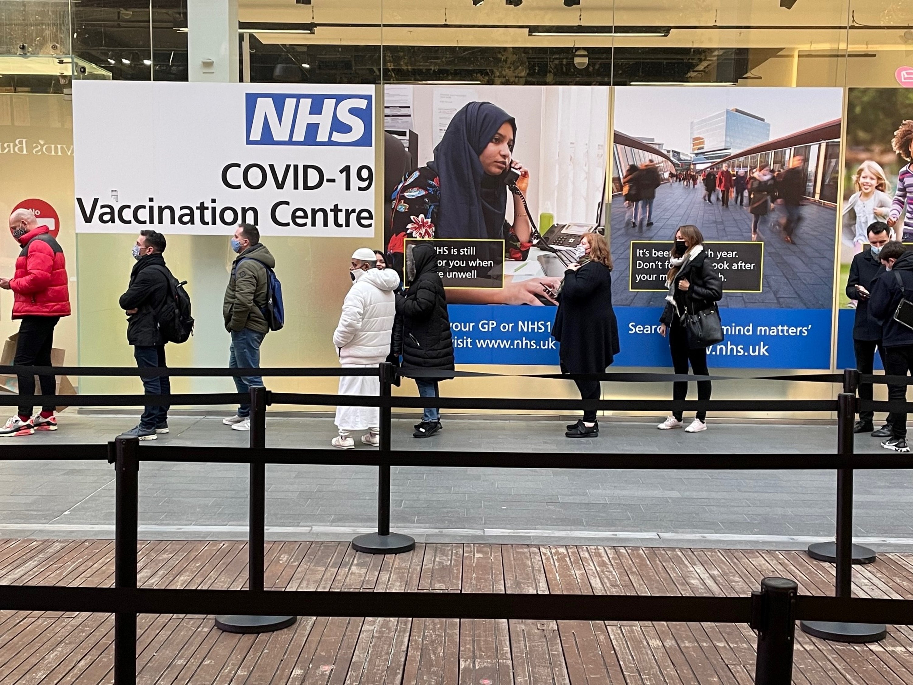 People queue at a Covid-19 vaccination centre at the Westfield in Stratford, east London