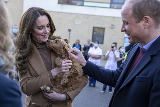 The Duke and Duchess of Cambridge meet new therapy puppy Alfie, an apricot cockapoo, during a visit to the Clitheroe Community Hospital in Lancashire (James Glossop/The Times/PA)