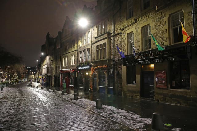 An empty Grassmarket in Edinburgh on Hogmanay as large-scale celebrations were cancelled (PA)