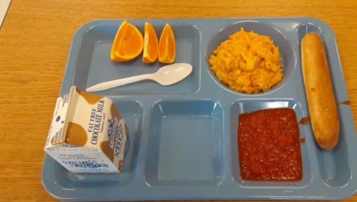 Egg and a bread roll, with three orange slices, is served for lunch at one upstate New York school