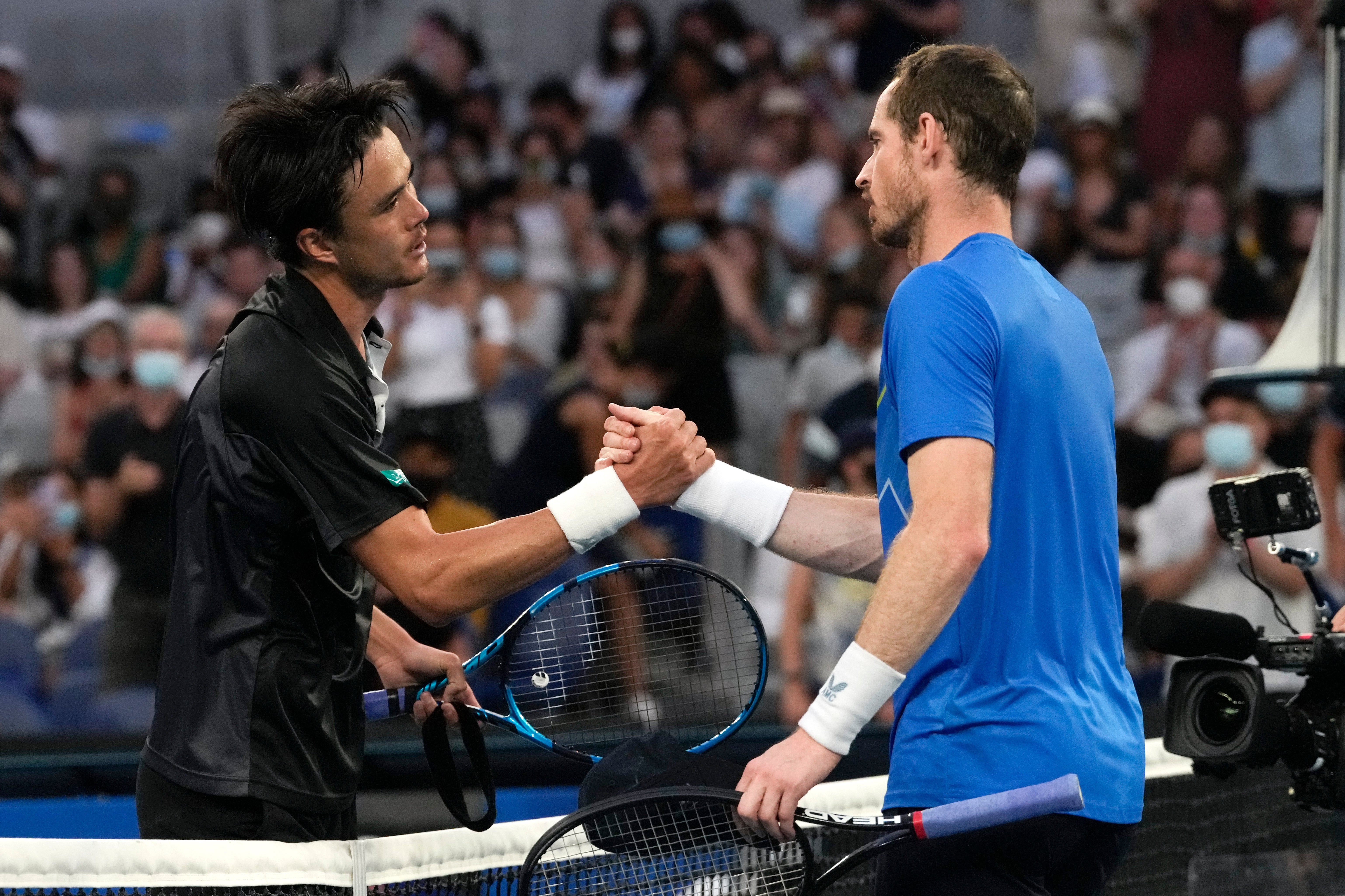 Andy Murray, right, bowed out of the tournament after defeat by Taro Daniel (Simon Baker/AP)