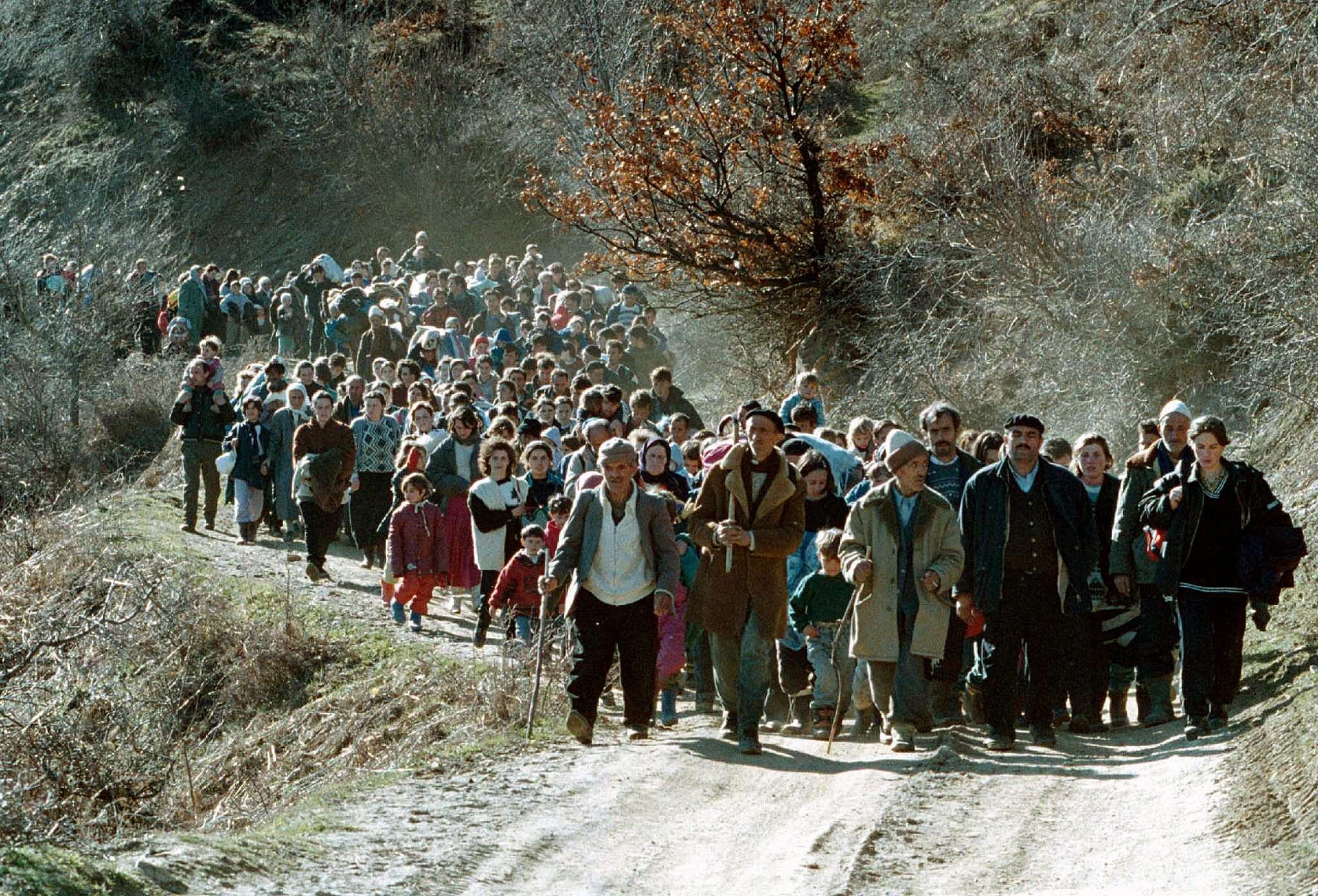 A line of ethnic Albanian refugees flee on a small road in the mountains near Kacanik, about 60km south of Kosovo's capital, Pristina, March 1999