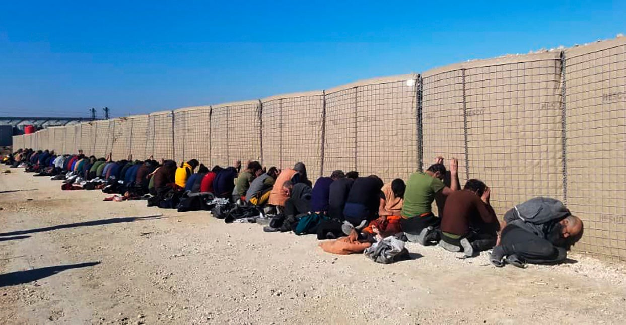 A photo provided by the Kurdish-led Syrian Democratic Forces shows arrested Isis fighters after they attacked Gweiran Prison