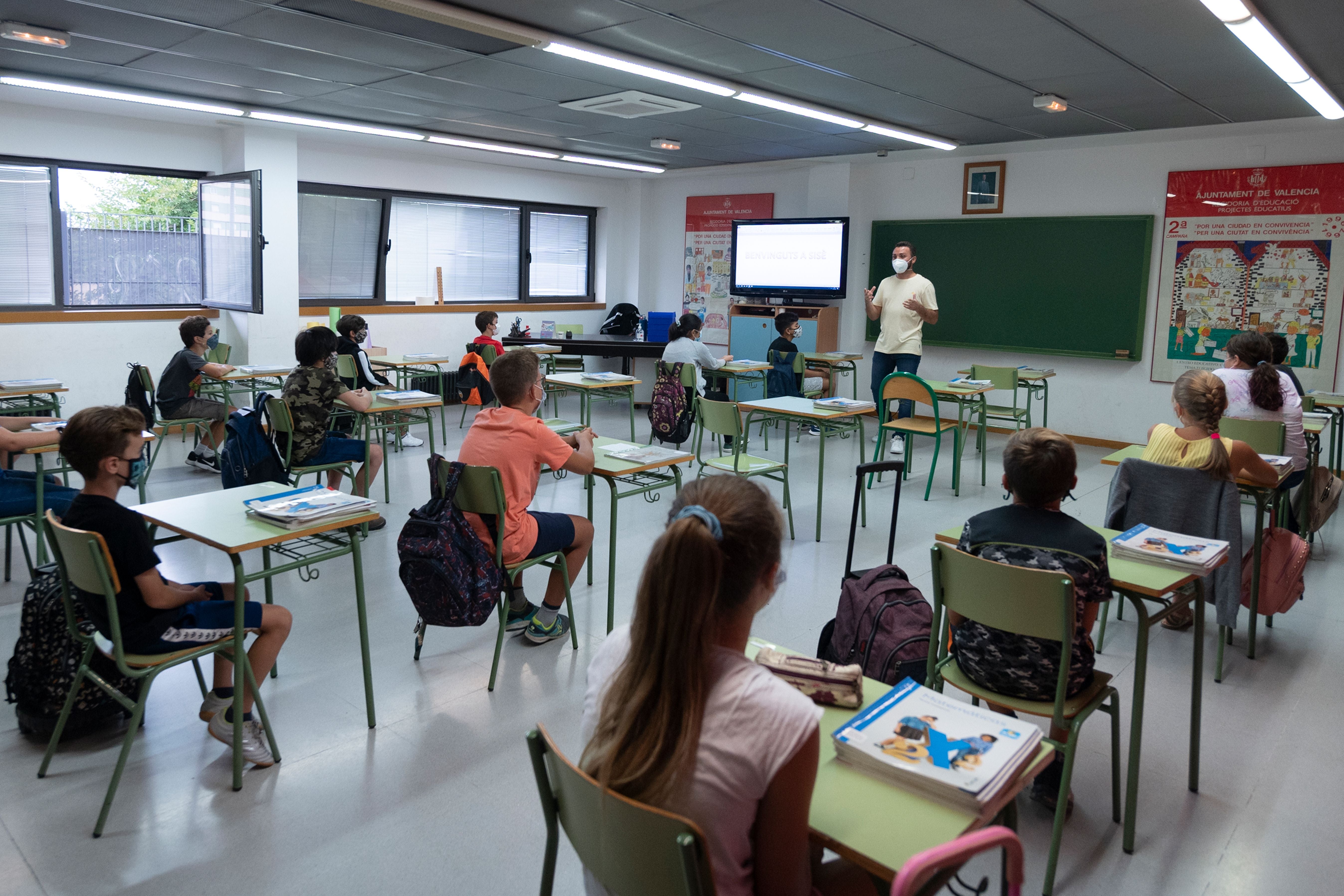 File photo: Students wearing face masks and sitting at a distance from each other attend class at a municipal school in Valencia, 7 September 2020