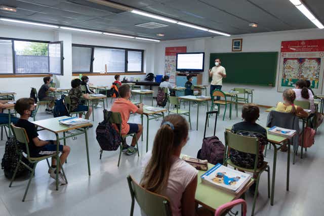 <p>File photo: Students wearing face masks and sitting at a distance from each other attend class at a municipal school in Valencia, 7 September 2020 </p>