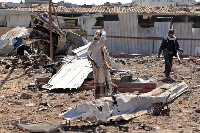 <p>Yemenis inspect the site of Saudi-led airstrikes targeting an automobile repair shop in Sanaa in December </p>