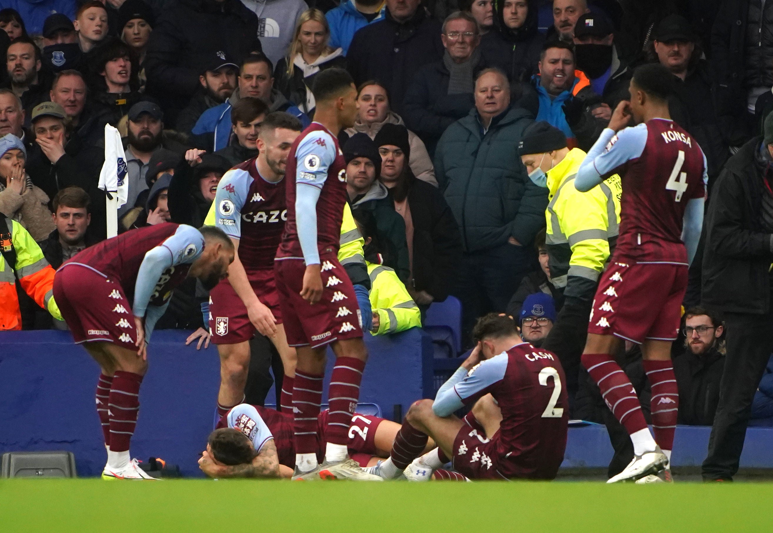 Aston Villa players react after a bottle is thrown from the stands