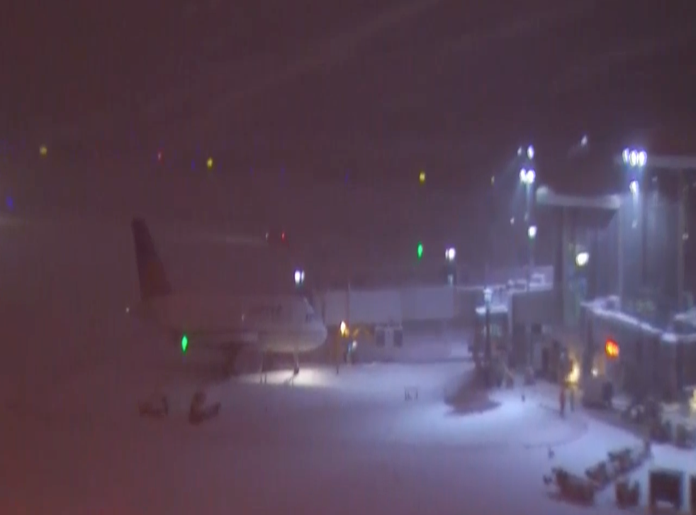 <p>An aeroplane sits on the snow at RDU, shortly after the Delta flight skidded off the runway. </p>