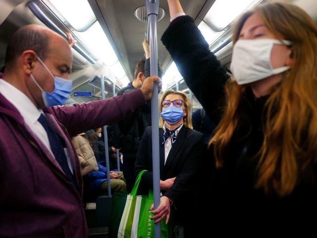 <p>Commuters on the Tube wearing Covid face masks </p>