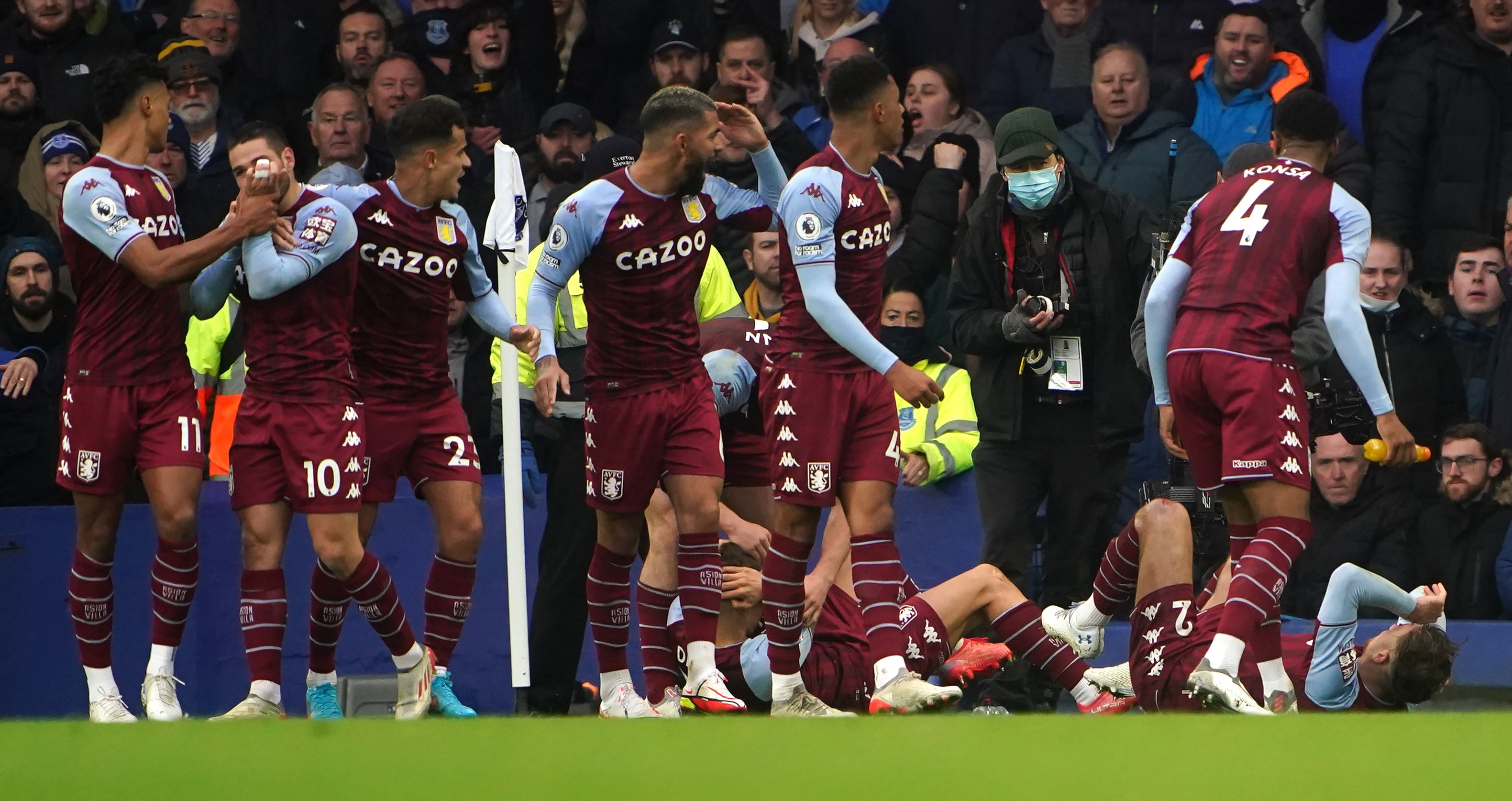 Aston Villa’s Lucas Digne and Matty Cash react to being hit by a missile at Goodison Park (Peter Byrne/PA)