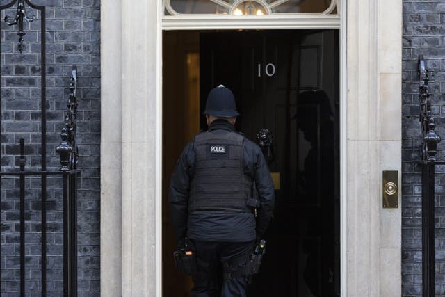 <p> A police officer entering 10 Downing Street last week </p>