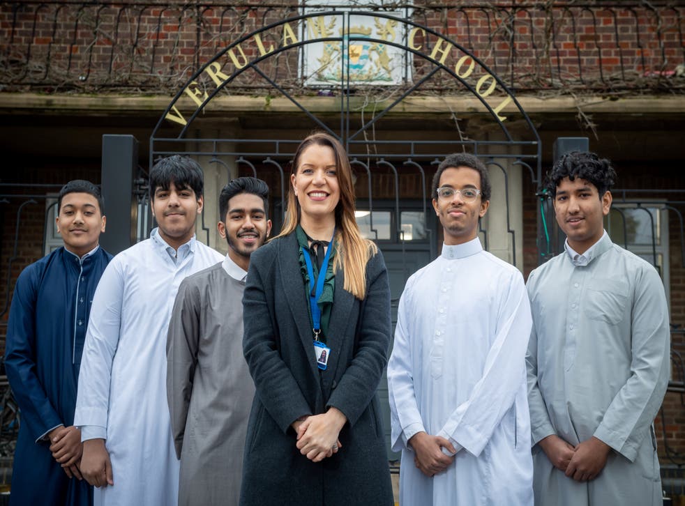 <p>Head teacher Julie Richardson and some students with hair styles and beards that would have been unacceptable under previous rules at Verulam School in St Albans</p>