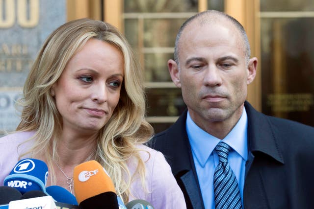 <p>Adult film actress Stormy Daniels, accompanied by her attorney, Michael Avenatti, right, talks to the media as she leaves federal court, on April 16, 2018 in New York</p>