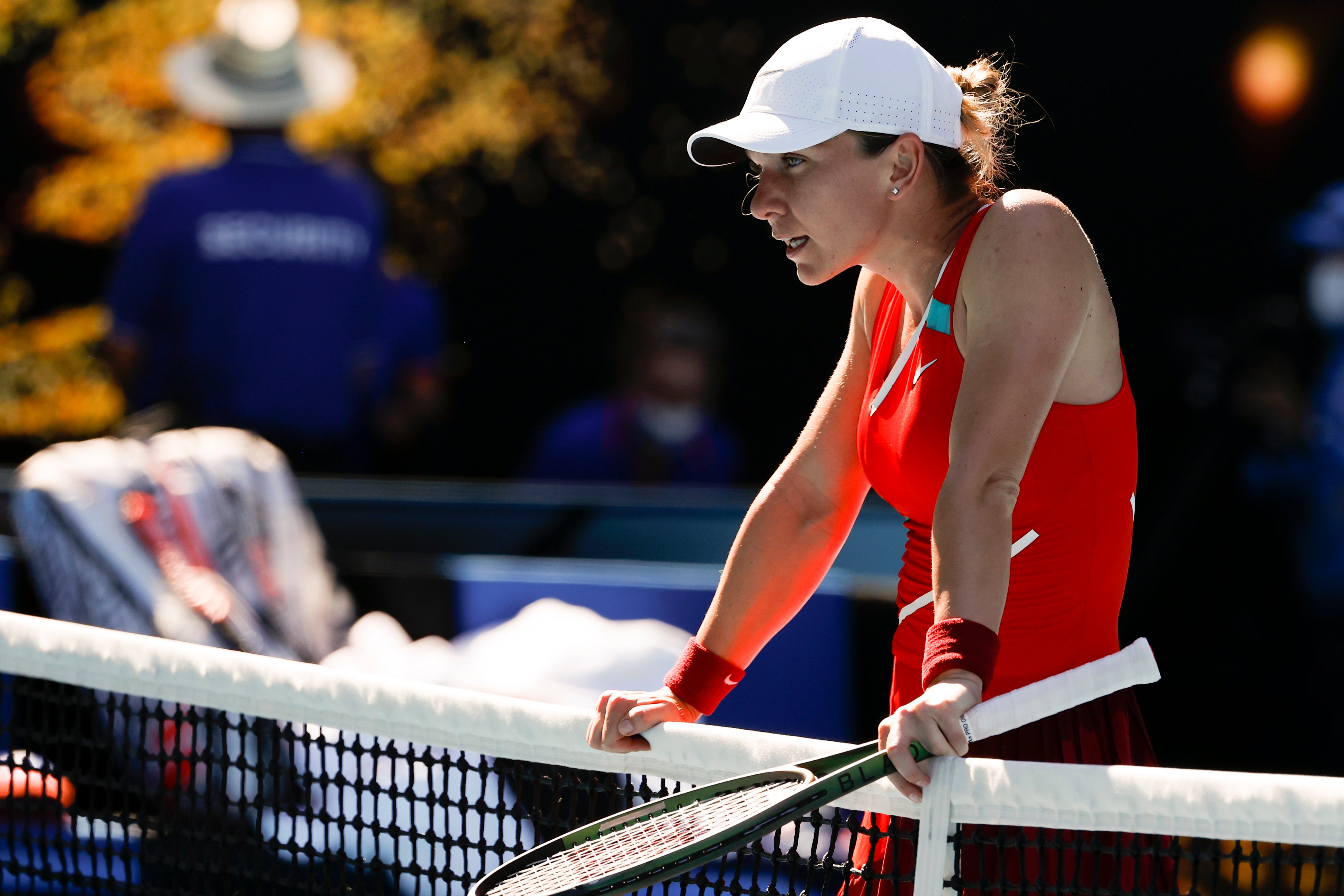 Simona Halep rests on the net at the end of her defeat by Alize Cornet (Tertius Pickard/AP)