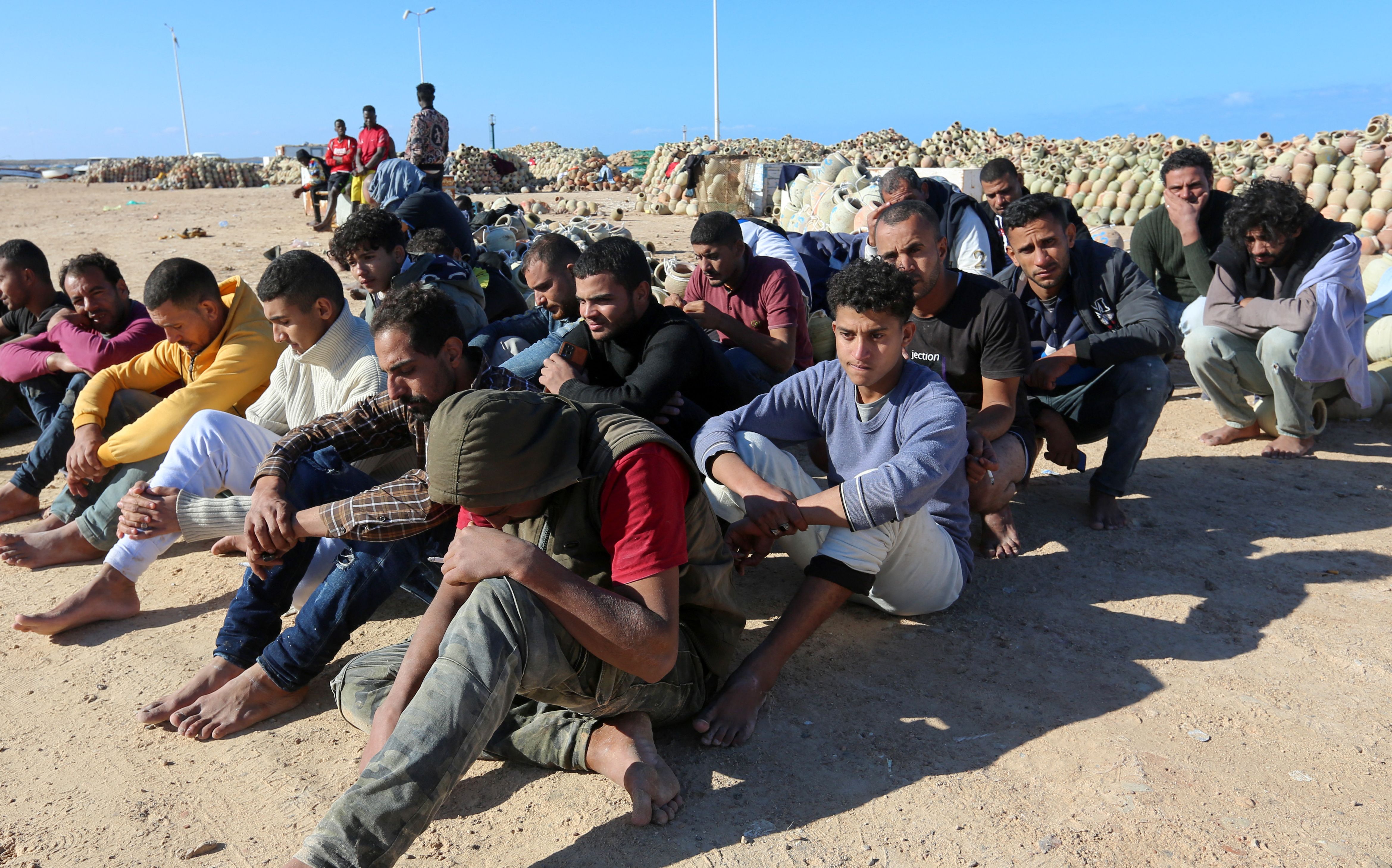 Migrants rescued by Tunisia’s national guard rest in Ben Guerdane, southern Tunisia, 15 December 2021