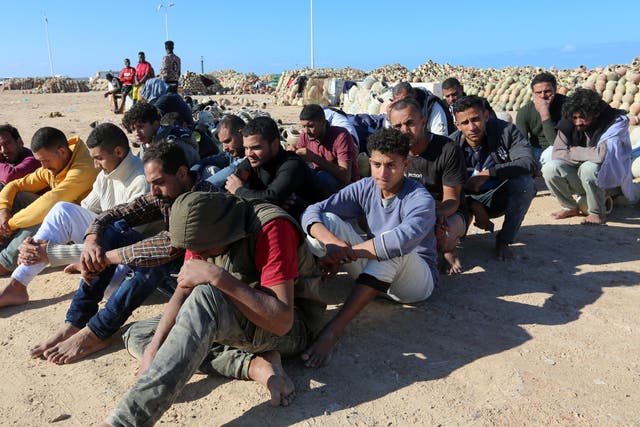 <p>Migrants rescued by Tunisia’s national guard rest in Ben Guerdane, southern Tunisia, 15 December 2021</p>