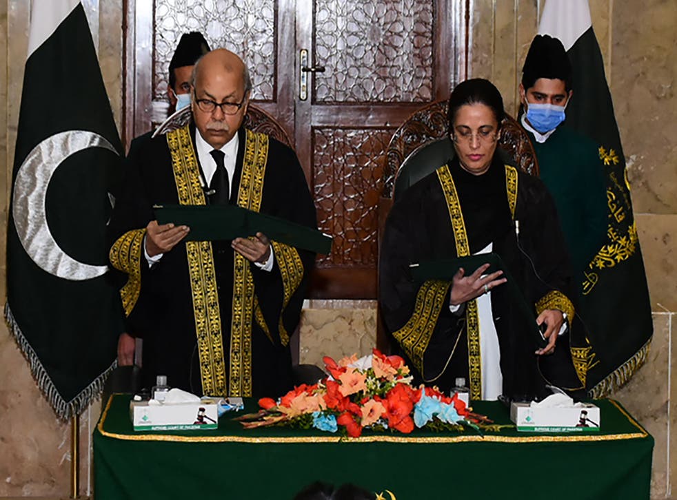<p>Chief justice Gulzar Ahmed (left) administering the oath to Justice Ayesha Malik as Pakistan's first female Supreme Court judge</p>