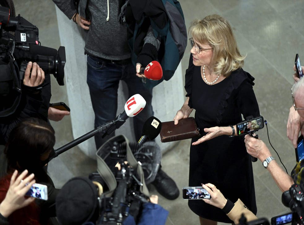 <p>Paivi Rasanen holding the Bible outside the court</p>