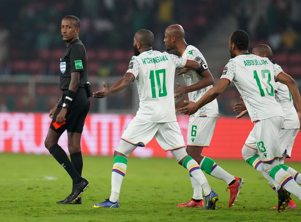 Referee Bamlak Tessema (left) prepares to show a red card to Comoros captain Jimmy Abdou (centre) at the Africa Cup of Nations round of 16 tie (Themba Hadebe/AP)