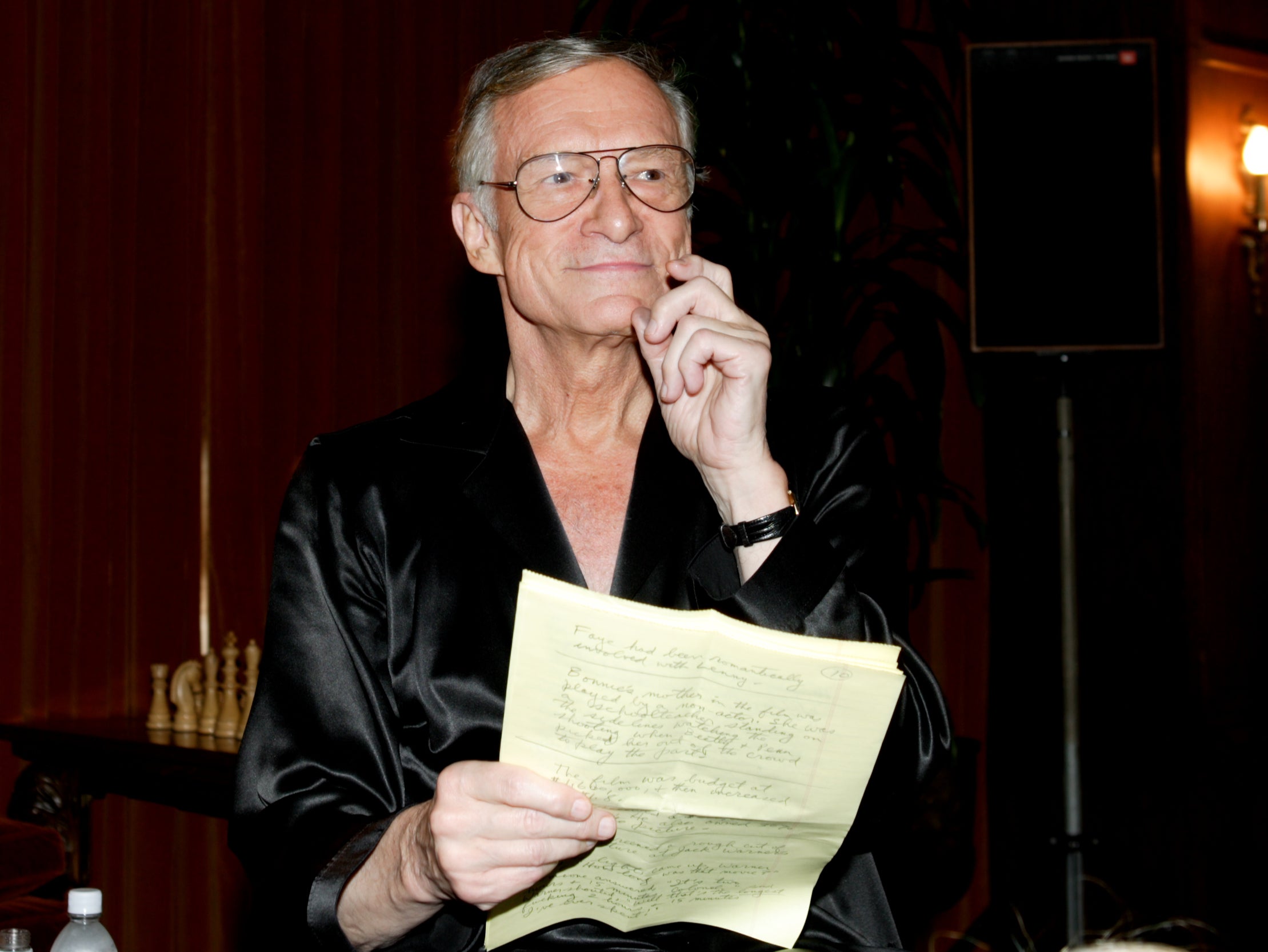 Hugh Hefner reads from his notes before a screening of ‘Bonnie and Clyde’ at the Playboy Mansion on 18 June 2004 in Los Angeles, California