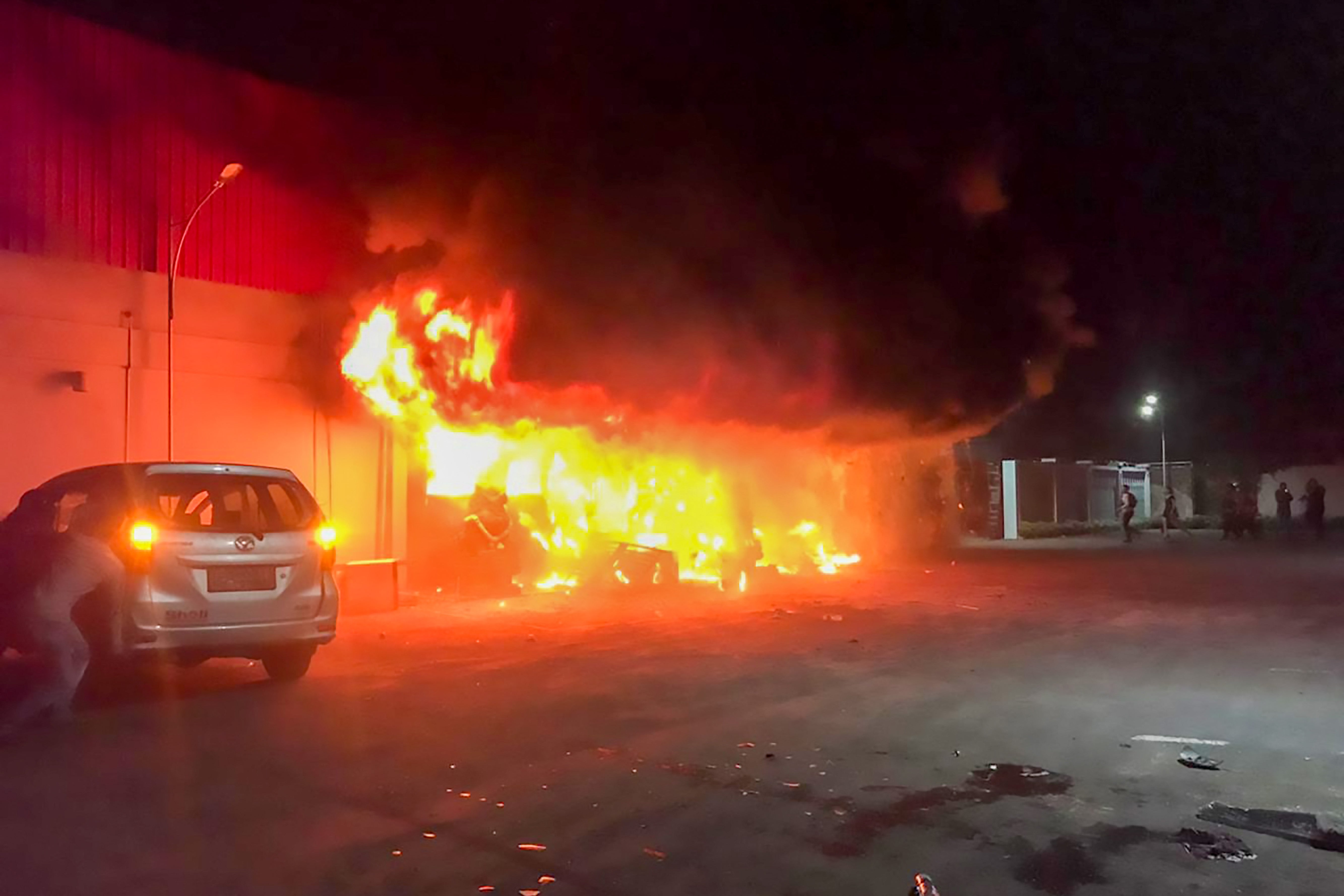 A fire burns at the Double O nightclub where at least 18 people were killed in clashes between two groups in Sorong in Indonesia’s West Papua province on 25 January 2022