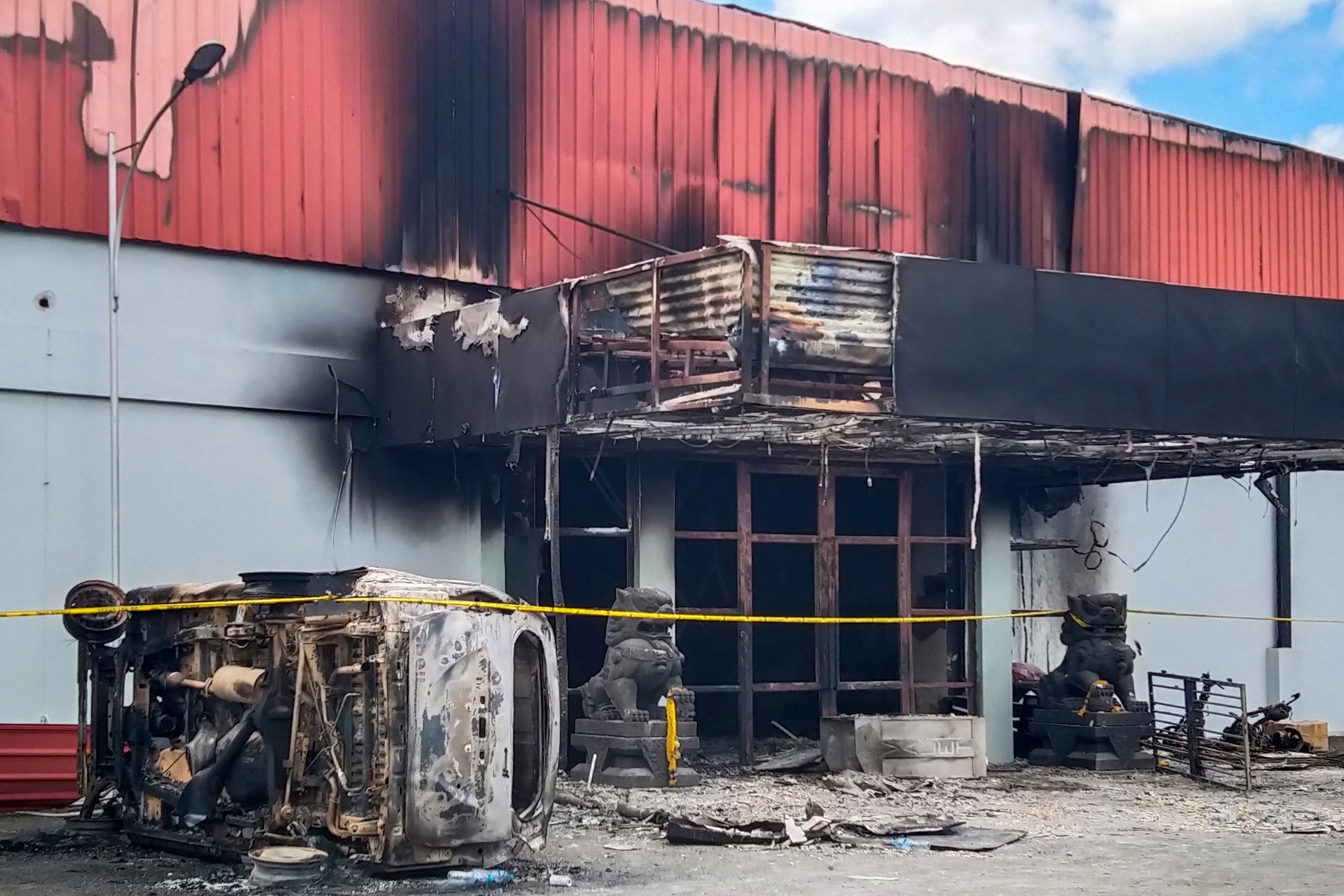 The burnt out Double O nightclub is seen where at least 18 people were killed in clashes between two groups, in Sorong in Indonesia’s West Papua province on 25 January 2022