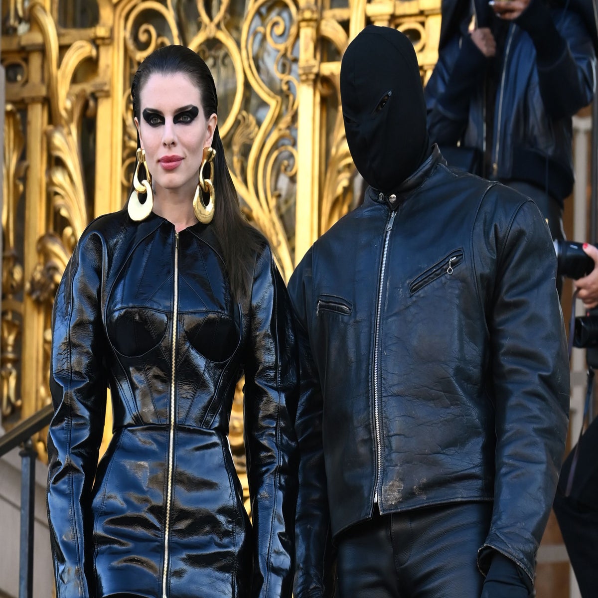kanye west using a full face covering black mask, a