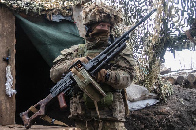 <p>A Ukrainian soldier stands at the line of separation from pro-Russian rebels, in the Donetsk region</p>