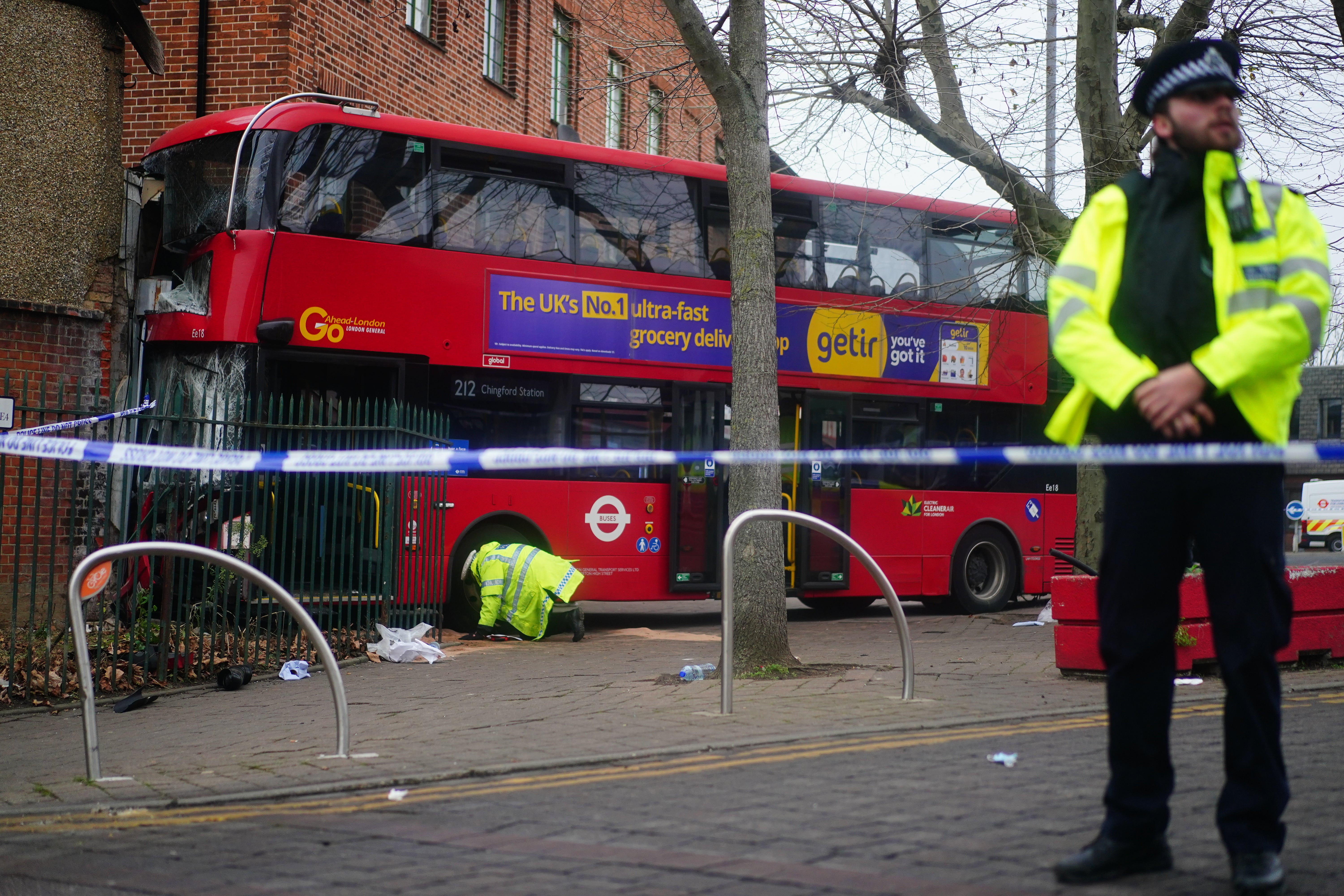 Emergency services at the scene on The Broadway in Highams Park, east London, where a number of people are being treated by paramedics from the London Ambulance Service after a bus collided with a building (Victoria Jones/PA)