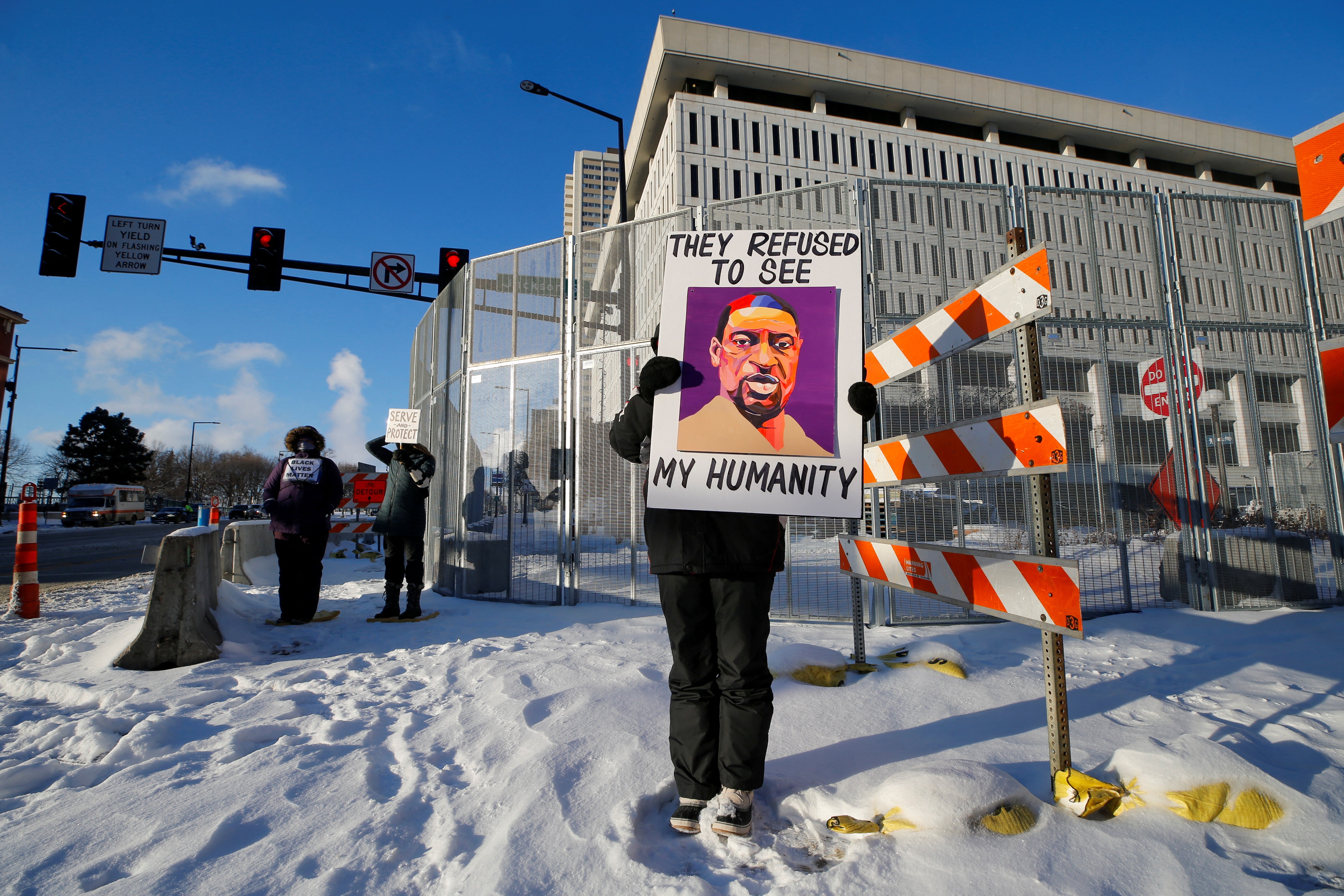 A protester stands outside a federal courthouse in St Paul, Minnesota on 24 January.