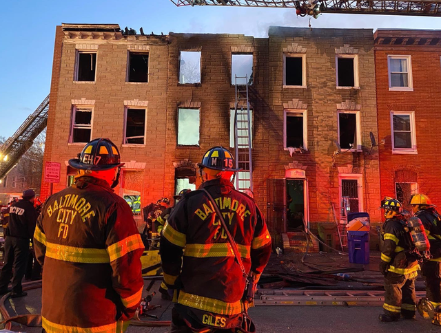 <p>Baltimore City firefighter at the scene of a building collapse that claimed the lives of three firefighters </p>