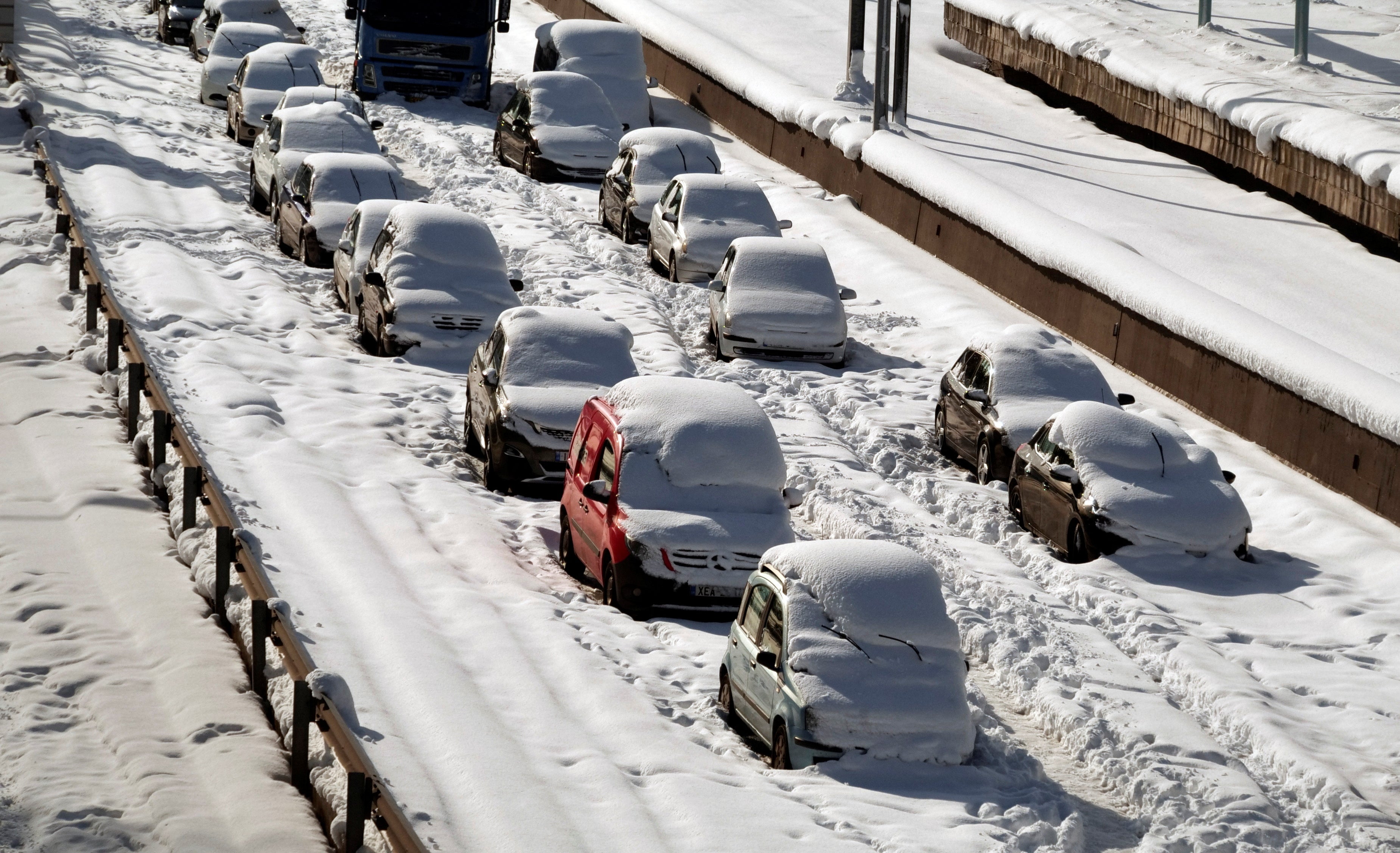Abandoned vehicles are covered in snow, following heavy snowfall in Athens