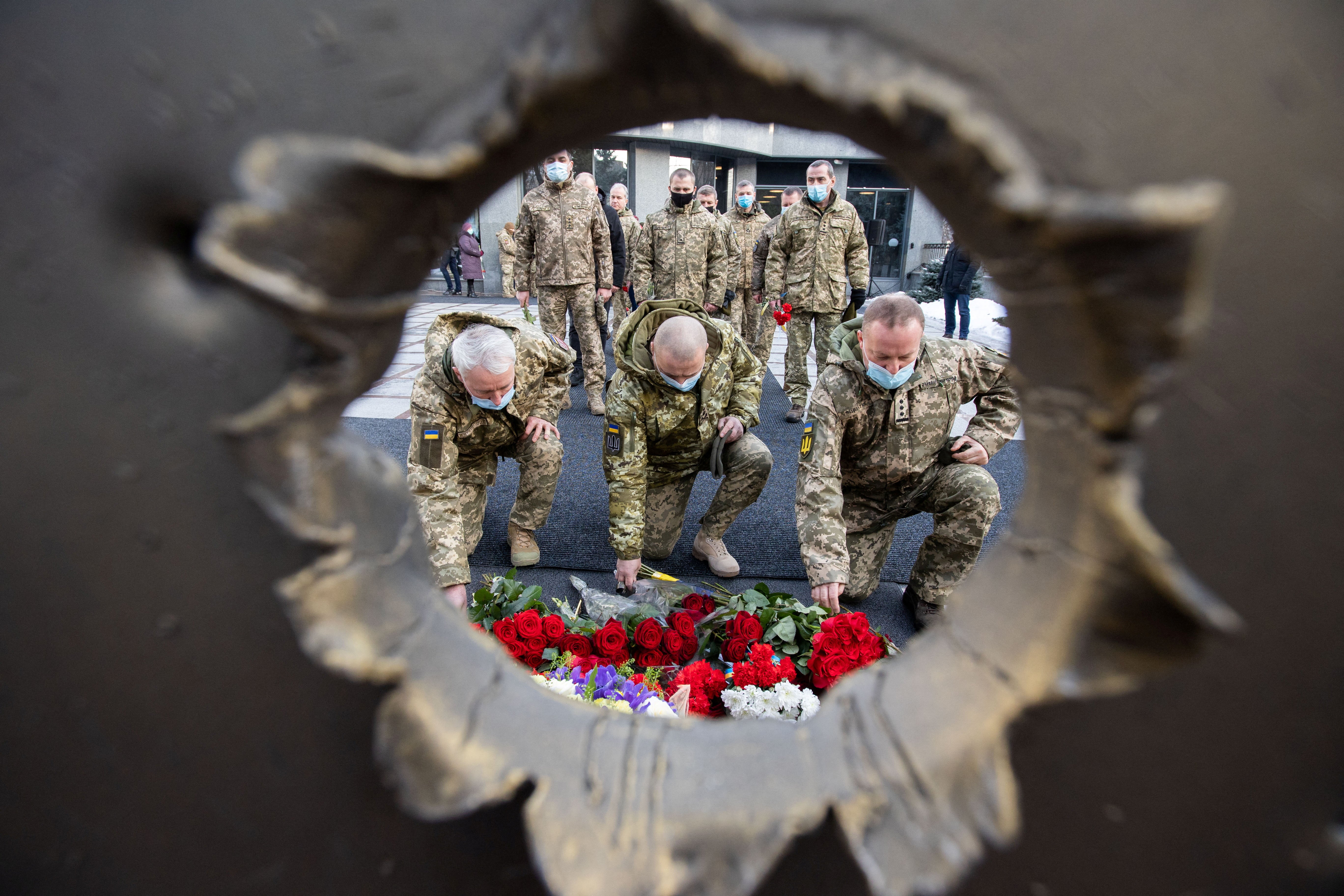 People attend a ceremony in tribute to fallen defenders of Ukraine