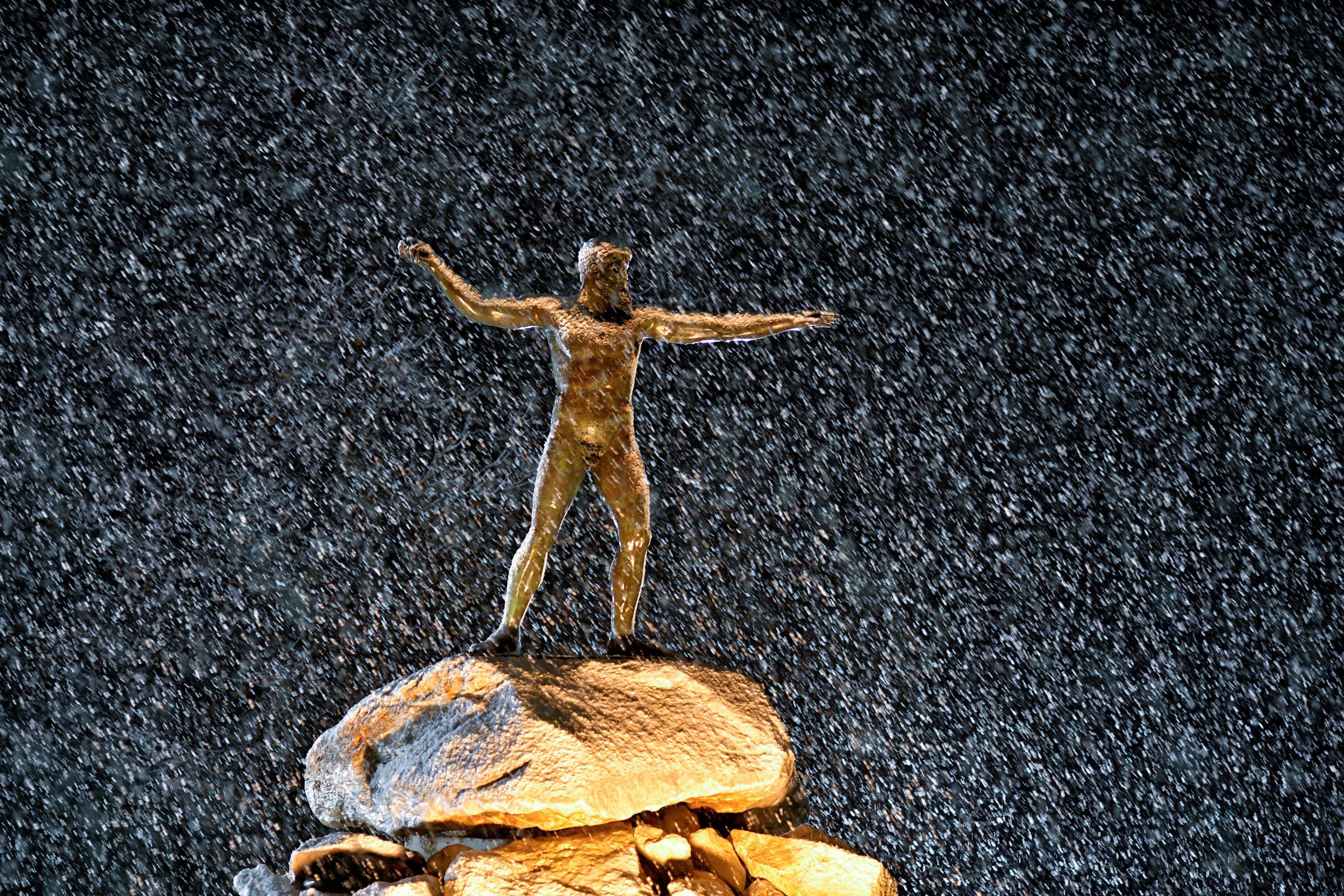 <p>The statue of Poseidon during snowfall in Corinth, Greece</p>