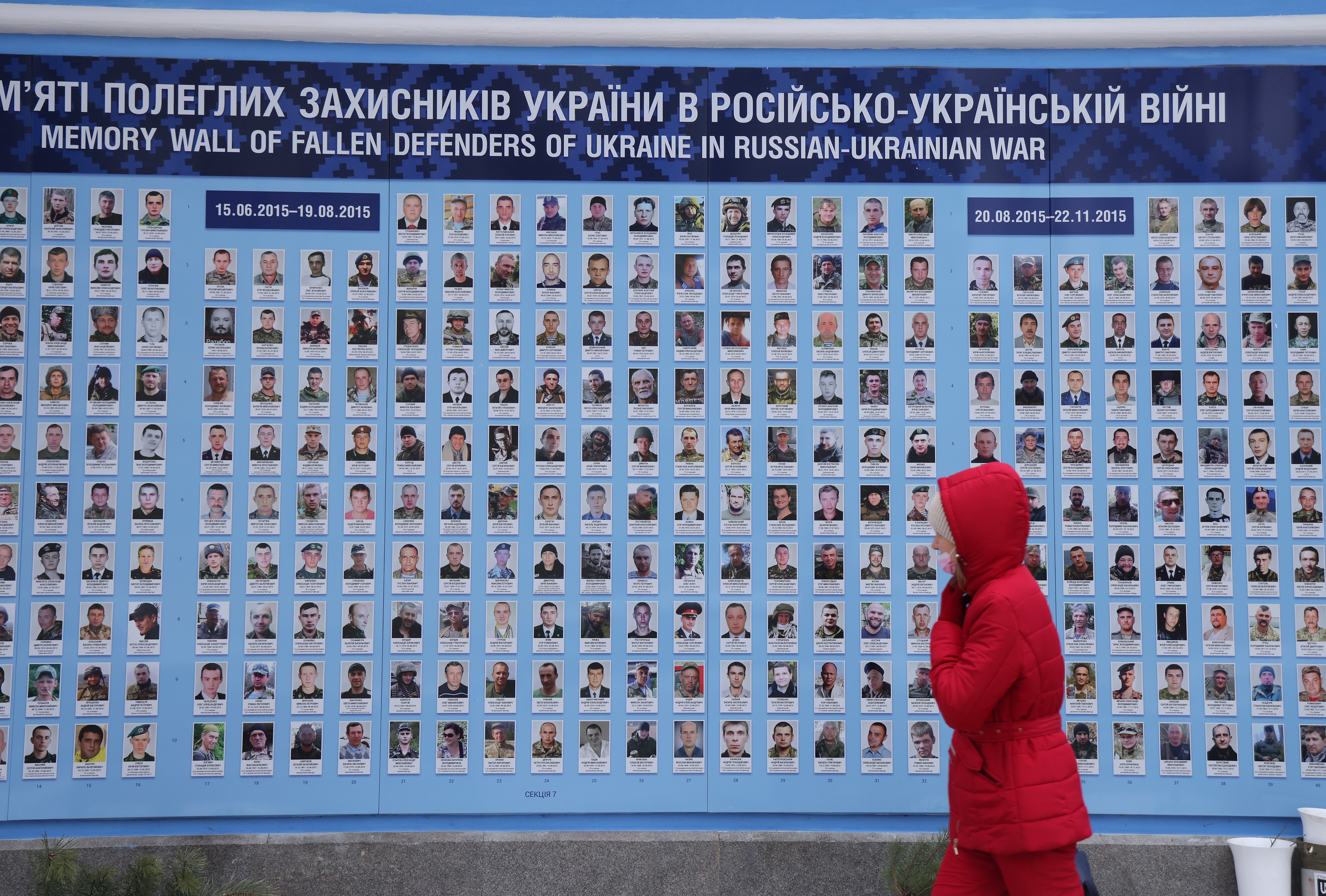A woman walks past the Wall of Remembrance for those who have died fighting for Ukraine in the ongoing Donbas conflict