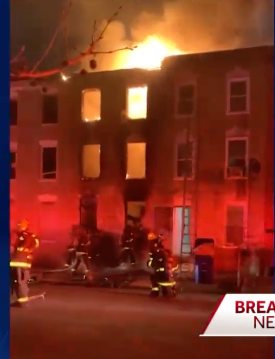 Firefighters battle the blaze in West Baltimore where three died when a building collapsed