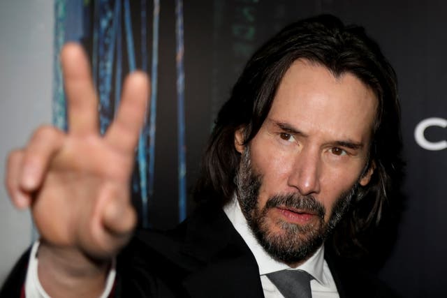 <p>Actor Keanu Reeves gestures during the ‘Black Carpet’ of the Canadian premiere of The Matrix Resurrections film </p>