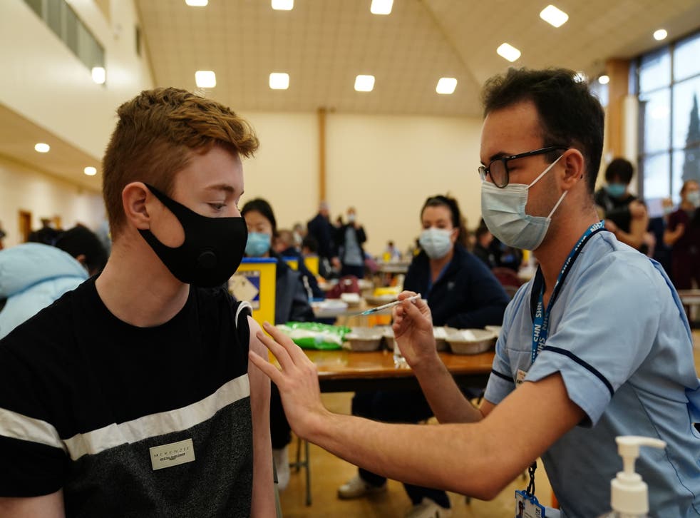 Owen Morrison, 15, receives a Covid-19 vaccine from student nurse Anthony McLaughlin at the Glasgow Central Mosque (Jane Barlow/PA)