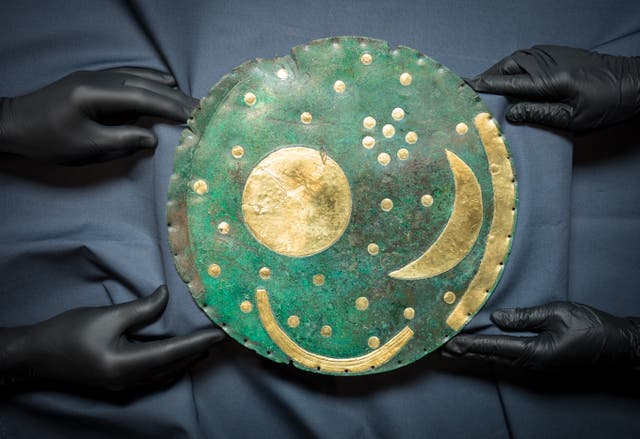 The Nebra Sky Disc, the world’s oldest map of the stars, as it is prepared for display as part of The world of Stonehenge exhibition at the British Museum in London (Dominic Lipinski/PA)