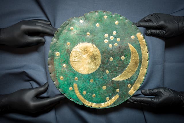 The Nebra Sky Disc, the world’s oldest map of the stars, as it is prepared for display as part of The world of Stonehenge exhibition at the British Museum in London (Dominic Lipinski/PA)